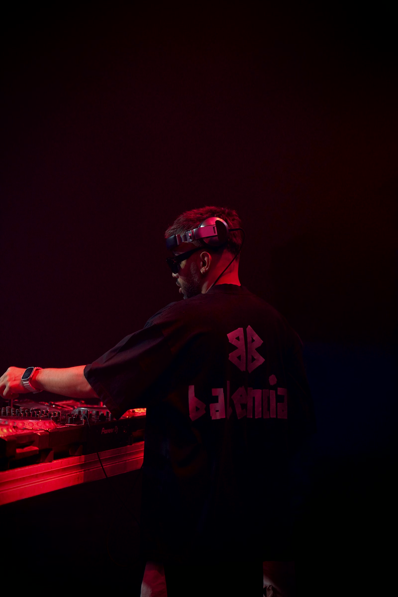 VAHIDJ performing under deep red stage light